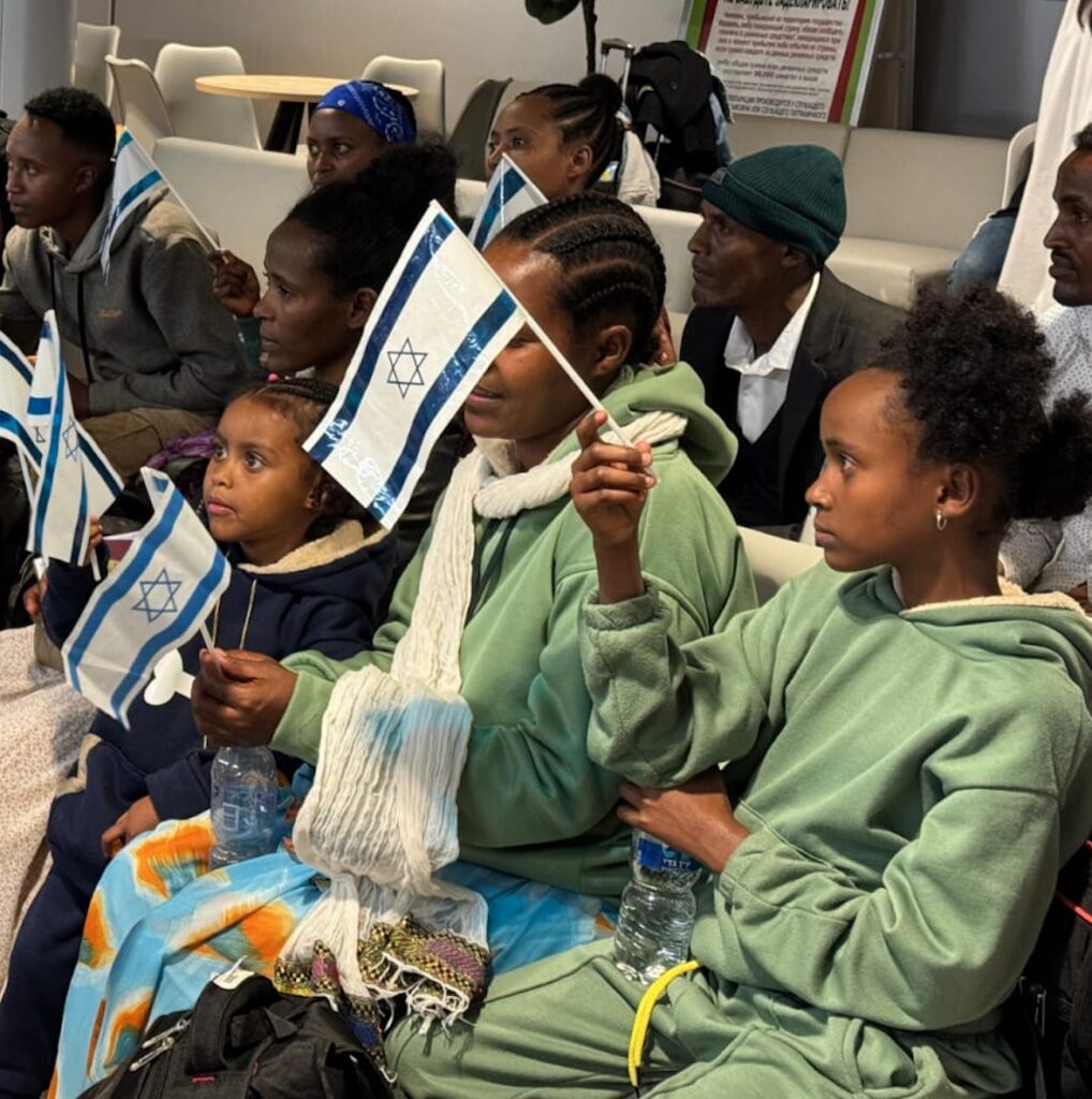 Ethiopian Aliyah: little girl holds Israeli flag upon arrival