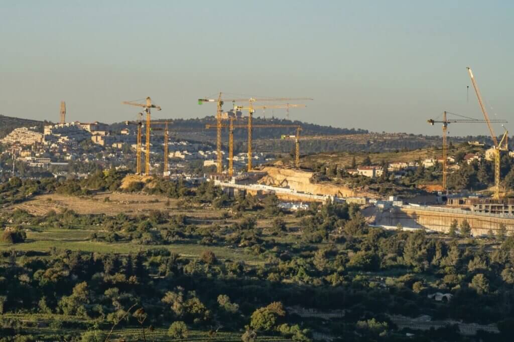 Construction cranes over the town of Mevaseret Zion near Jerusalem lower down