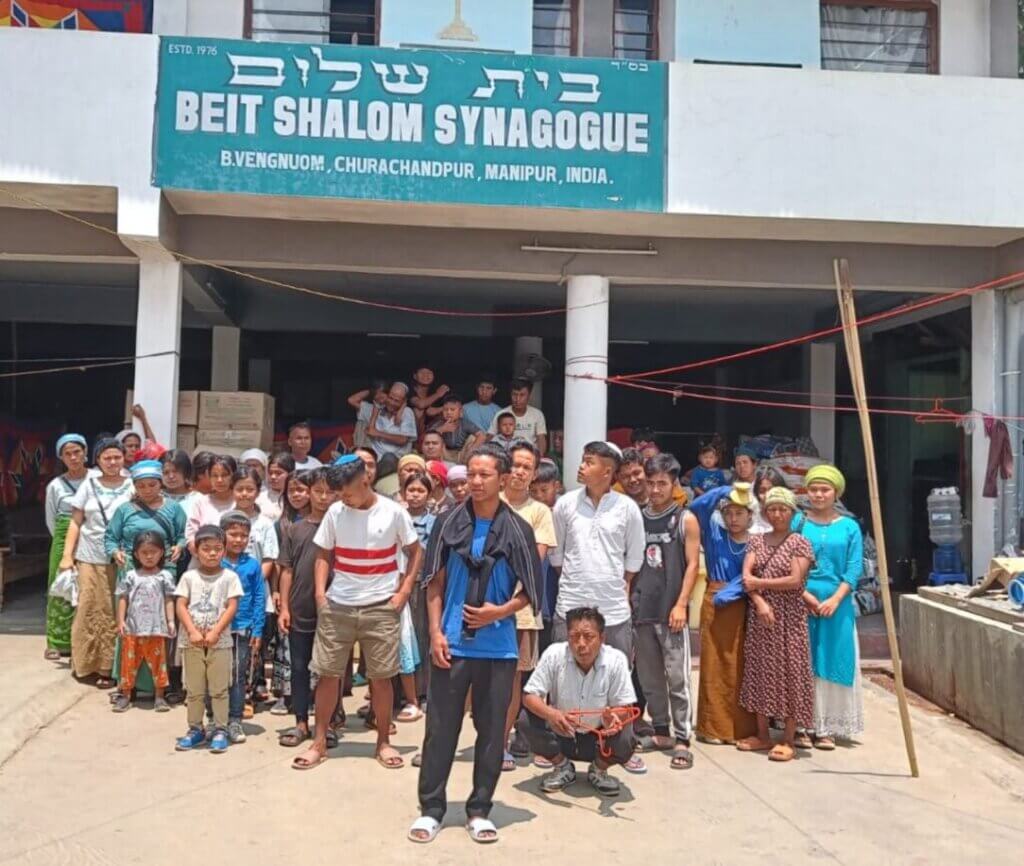Standing outside their synagogue are Bnei Menashe
