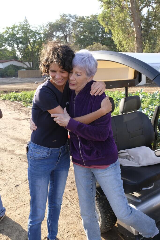 Jacqueline Glicksman is seen sharing a hug with ICEJ staff member Jannie Tolhoek.