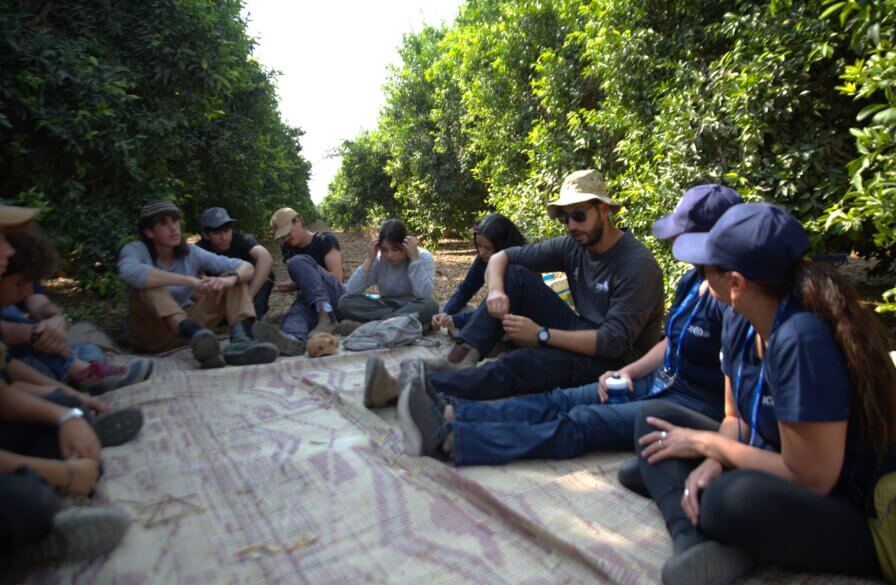 Tour member in the school orchard to harvest the fruit