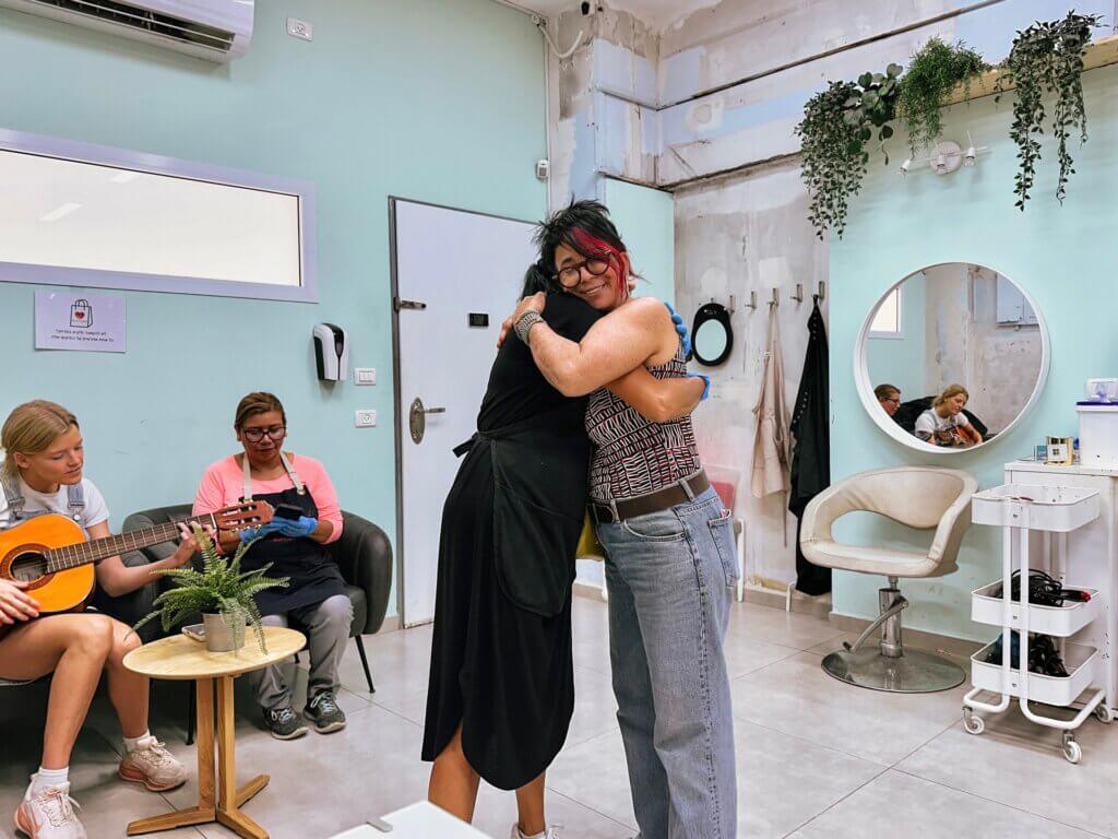 Anat is photographed hugging a woman who has been blessed by the love and service of the Red Carpet mission for years