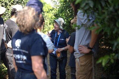 A tour member performs the Hebrew “Aleph-Bet” song for students while in the orchard