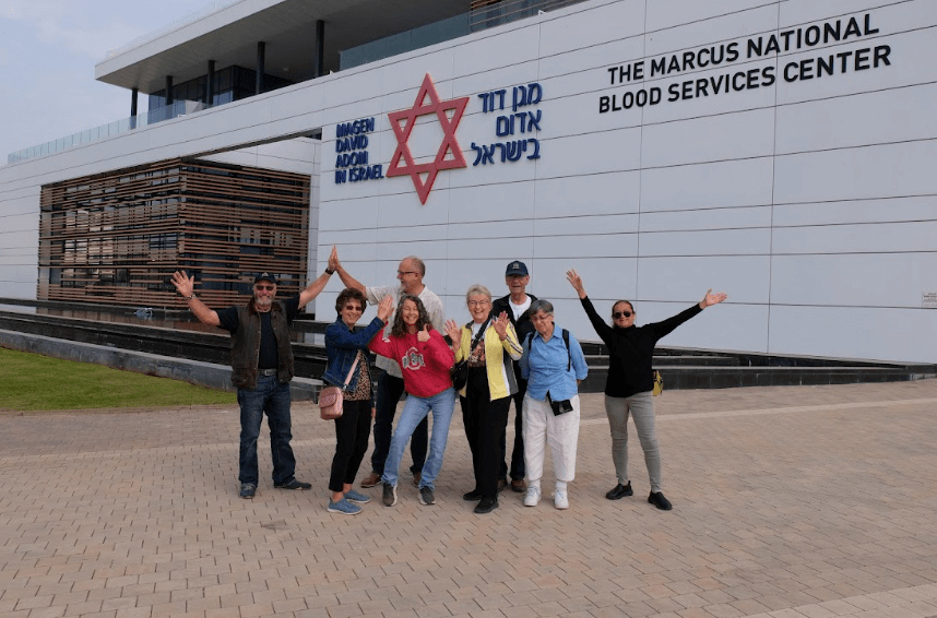 Tour member posing for a photo outside the Blood Services Center