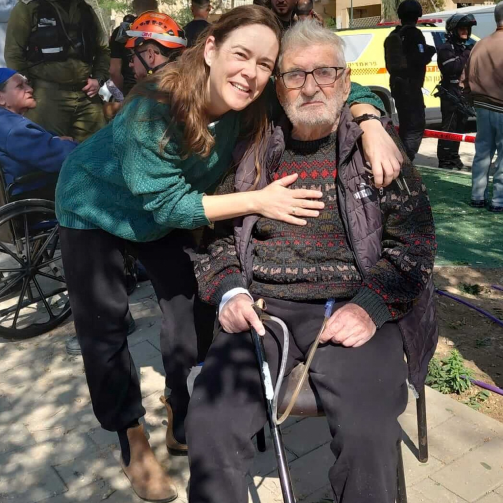 Outside his destroyed home photo shows Yoel and his daughter