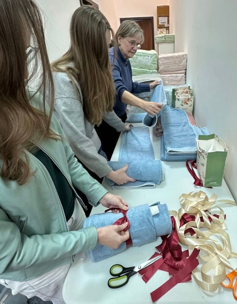 Photo shows the ICEJ staff packing towels and creams as gifts for Homecare visit