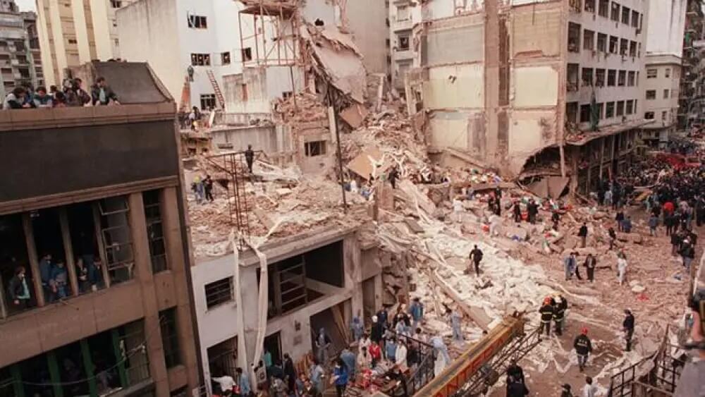 Photo shows the ruins of AMIA Jewish Community Center after the 1994 bombing in Buenos Aires (JNS via Wikimedia Commons