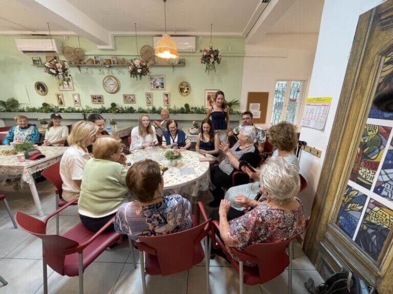 Holocaust survivors remember the Holocaust as they comfort each other.