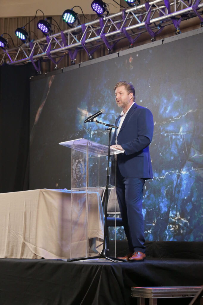 Photo shows Christopher Kuehl shares his message with the audience