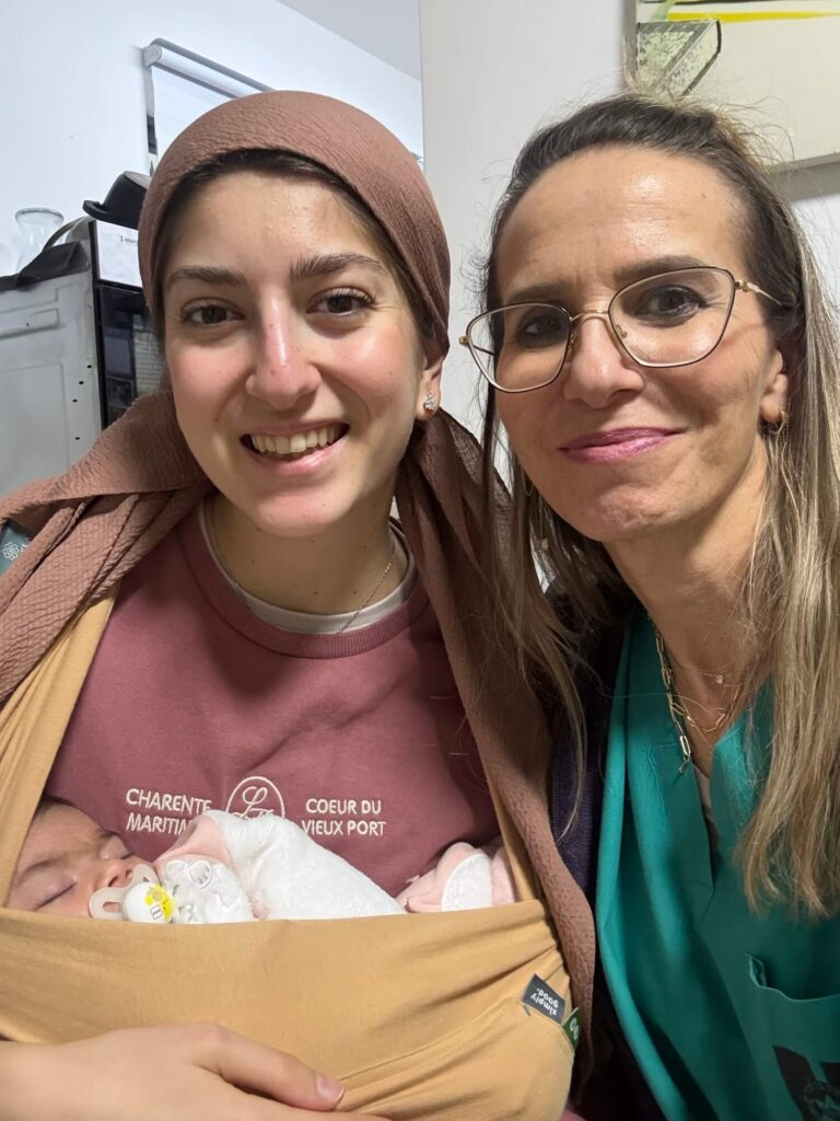 Picture shows Loren and her baby with their midwife, Naomi
